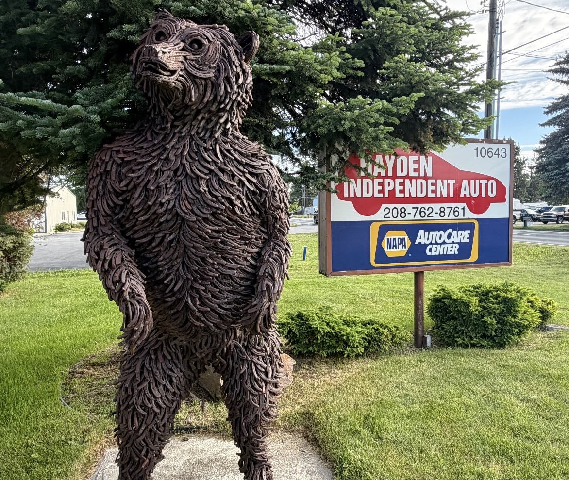 Eight-foot horseshoe grizzly bear sculpture outside Hayden Independent Auto Service
